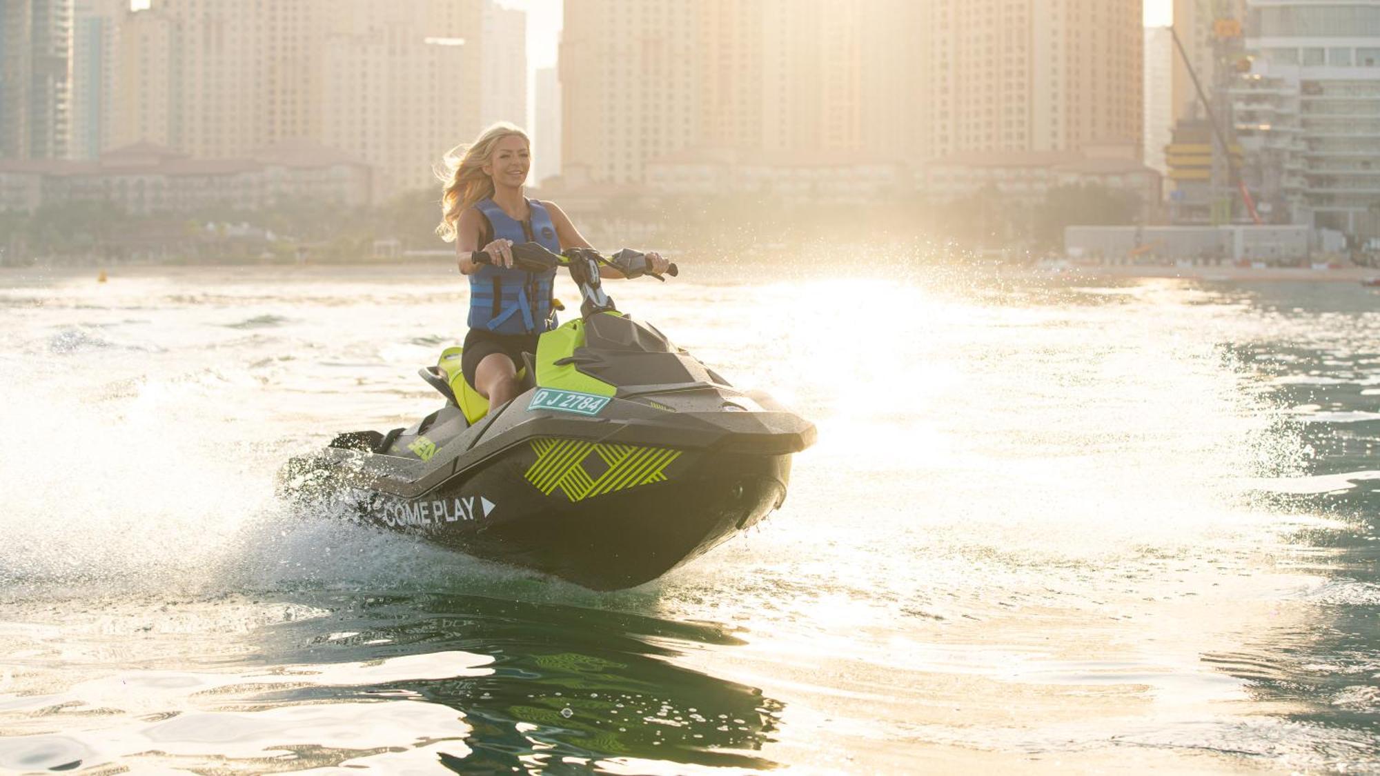 Five Luxe Hotel Dubai Buitenkant foto A woman riding a personal watercraft